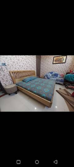 wooden bed with mattress