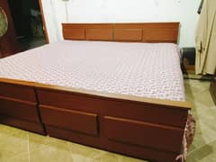 2 wooden single beds