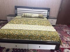 white king size bed with 2 side tables and dressing