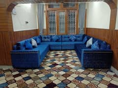 Luxurious U-Shaped Blue Sofa with Decorative Pillows
