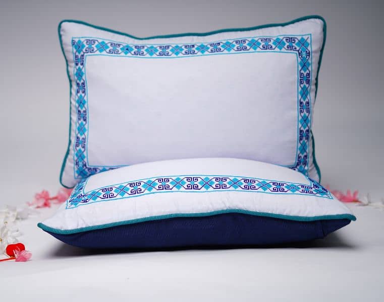 A pair of Borderline Cross-stitched pillowcases 0