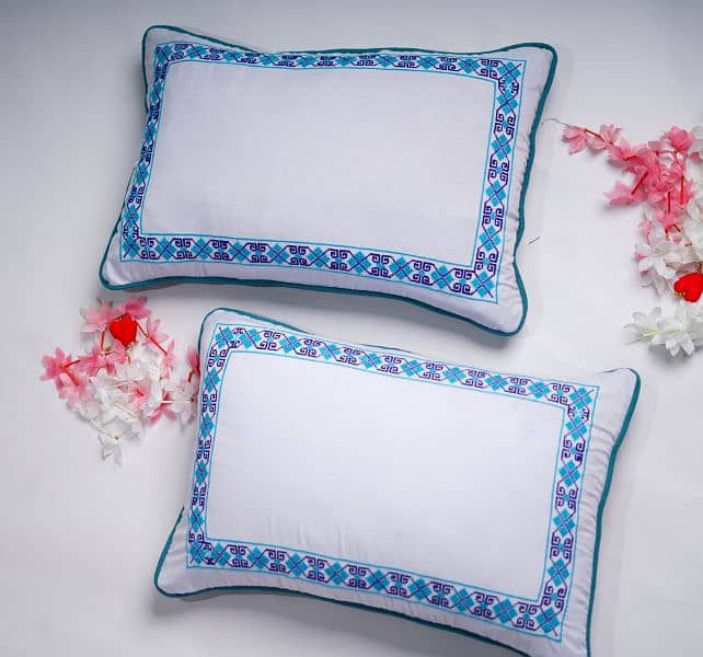 A pair of Borderline Cross-stitched pillowcases 3