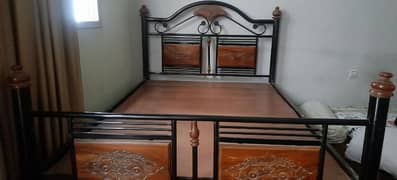 single iron bed with wooden texture .