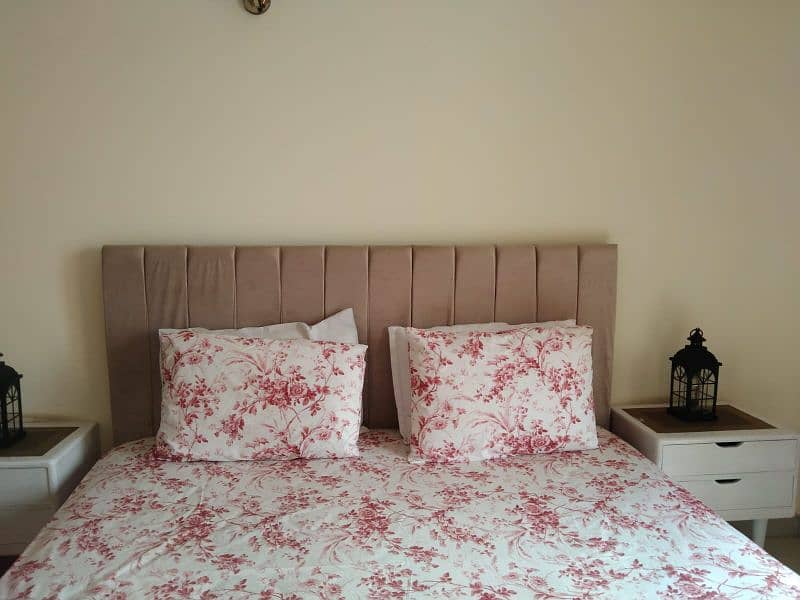 Tufted double bed with side tables 1