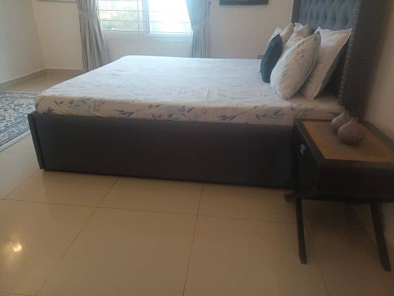 tufted double bed with two side tables 2