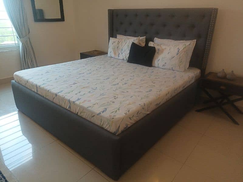 tufted double bed with two side tables 3