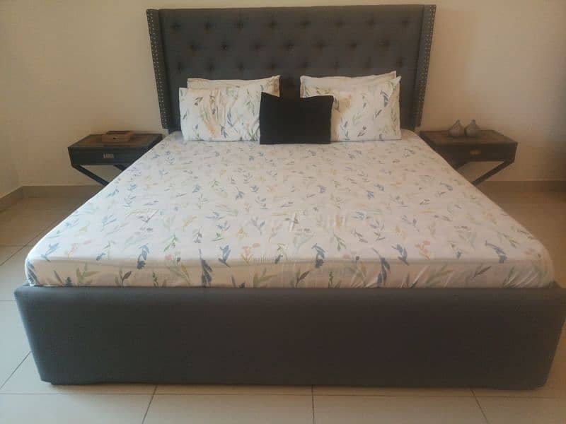 tufted double bed with two side tables 4