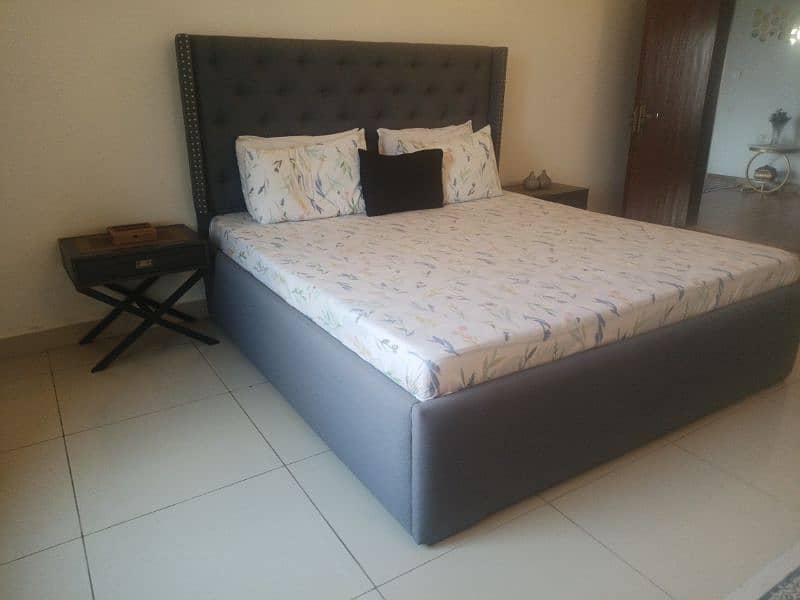 tufted double bed with two side tables 5