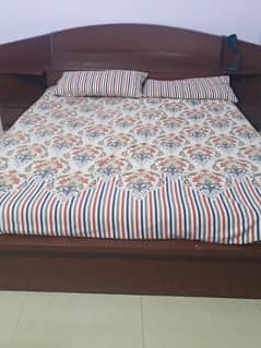 queen size bed round shaped with two side table with mattress.