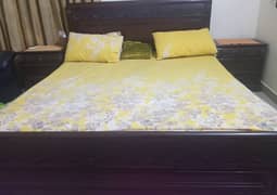queen size double bed with side tables and mattress.