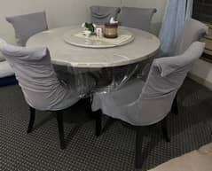 Marble rotating dining table with chairs is for sale