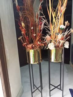 stylist metal pots with dry arrangements