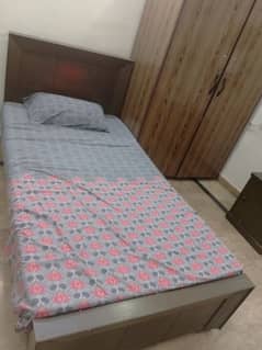 single bed with mattress and side table