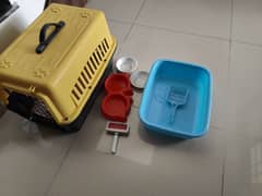 pet carrier , litter box , food tray , brush