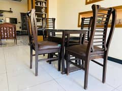 4 seater dining table with chairs and a small center table