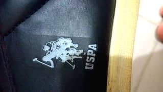 un use  shoseas of uspa brands in black colour and skinn  soul