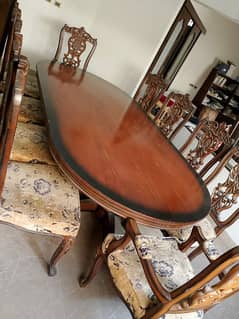 Dining table with 10 upholstered chairs, side board and mirror.