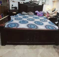 Wooden bed with one side table