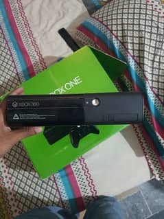 xbox 360 slim with 2 controllers and 5 games.