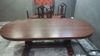 Big wooden dining table with 8 chairs