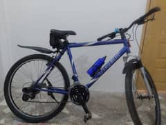 Trek cycle with seven speed gears and shocks.