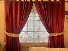 Red curtains with blinds in beige colour