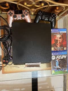 PS4 SLIM(1TB Used) with two games and two controllers.