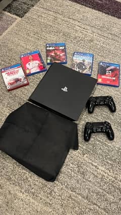 PS4 pro with 2 original controllers and with 5 CDs