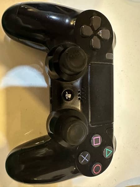 PLAYSTATION 4 WITH CONTROLLERS AND 4 games 5