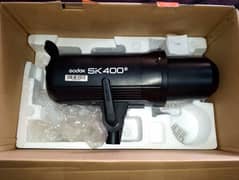 Godox sk 400ii speed light and video light.