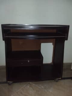 A dark brown coloured computer table