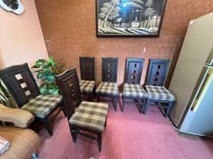 six dark brown wooden cushioned dinning chairs 0