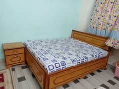 double bed with side table and mattress