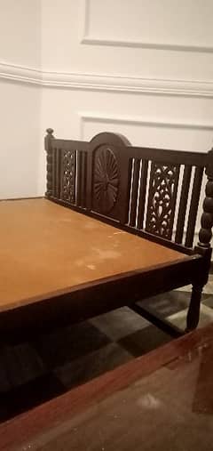 vintage bed with dresser and a side table.