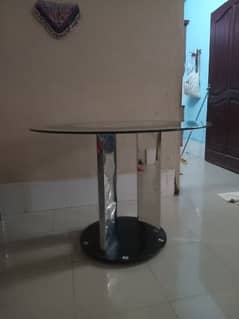 round glass table with two chairs