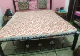 Metal bed frame with mattress and side tables 0