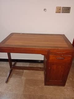 A table with a drawer and cabinet