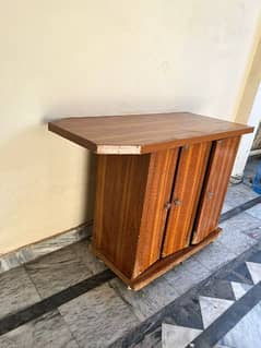 Wooden iron stand with a cabinet.