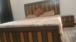 Wooden bed with side table and without mattress