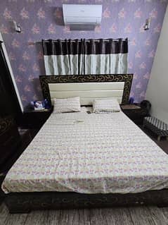 King size bed with two side tables and a dressing