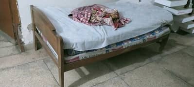 single wooden bed with 2 side tables