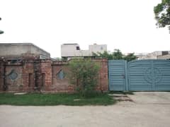 open plot with boundry wall gate and single room with washroom