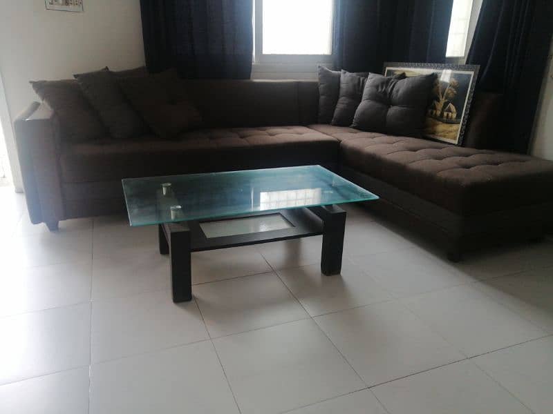 6 seater L-shaped sofa with center table. 0