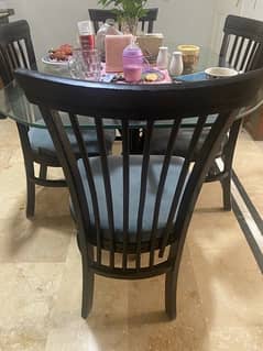 Iron Rod dining Table with glass and wooden chairs