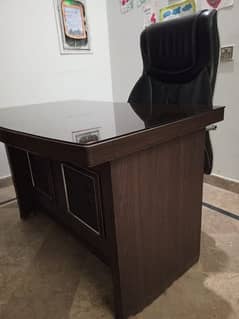 office table with glass top and boss chair black leather