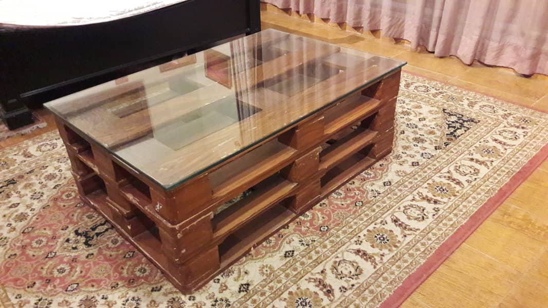 Centre table , with thick glass top , wooden base 1