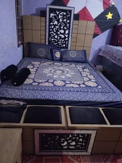 A double bed set with two side tables dressing table and mattress