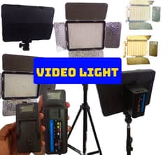 video light with battery, charger and stand.