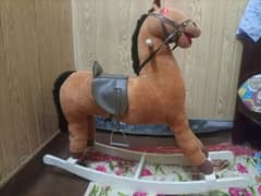 Swinging musical horse