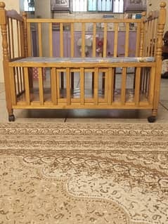 Baby Cot with 2 foldable doors and storage space.